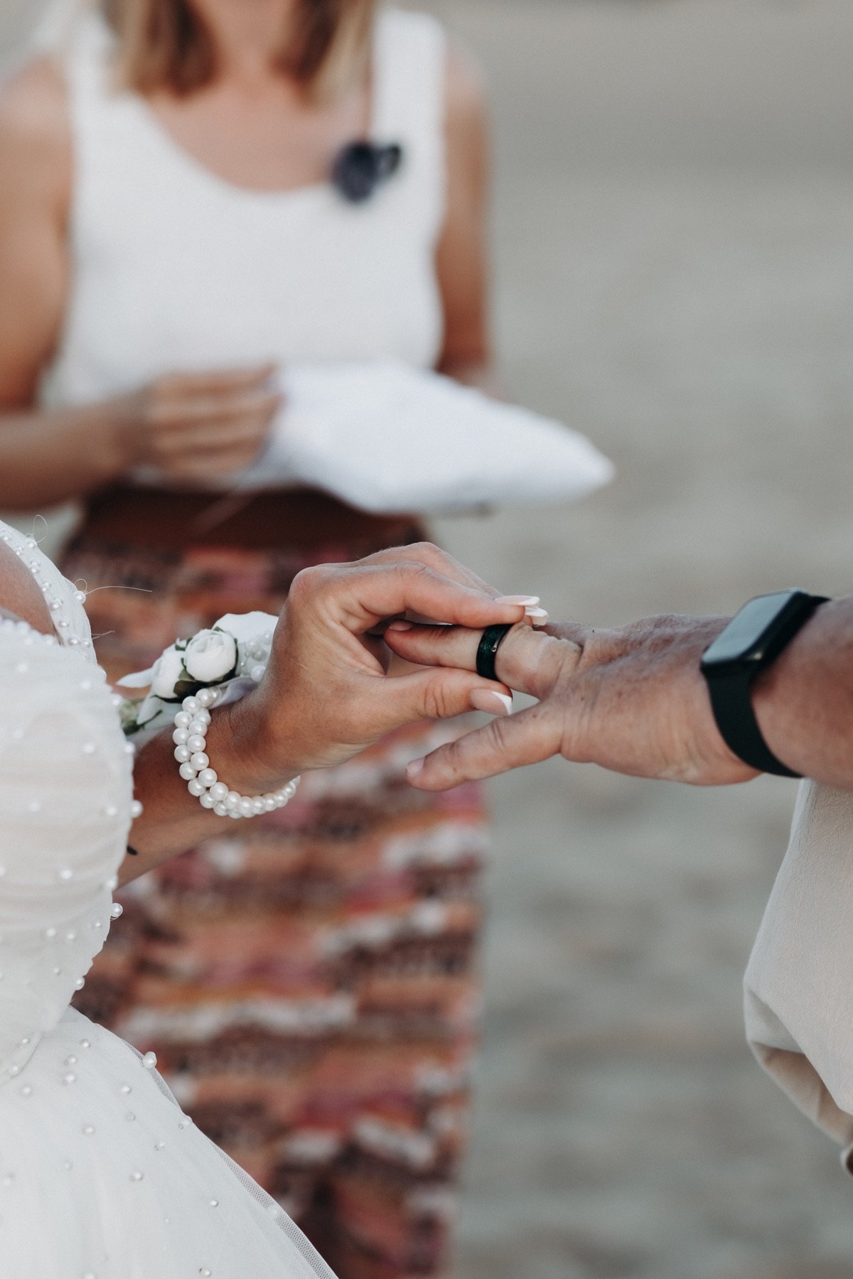 A bride places a wedding ring on her partner’s finger during a trilingual symbolic ceremony